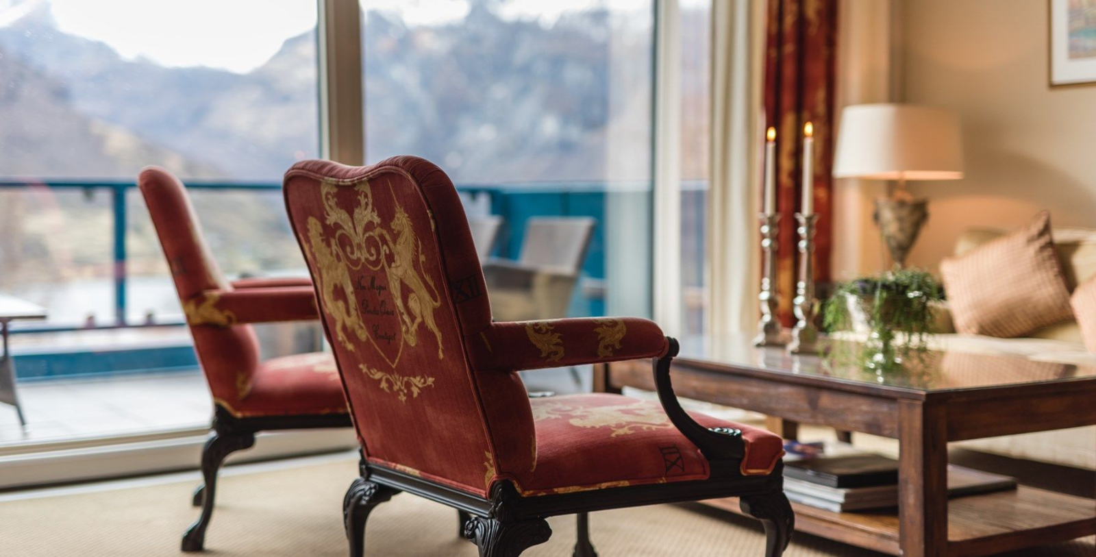 Image of guestroom seating area and balcony with fjord view at Hotel Union Geiranger in Geiranger, Norway, 1891, a member of Historic Hotels Worldwide since 2023