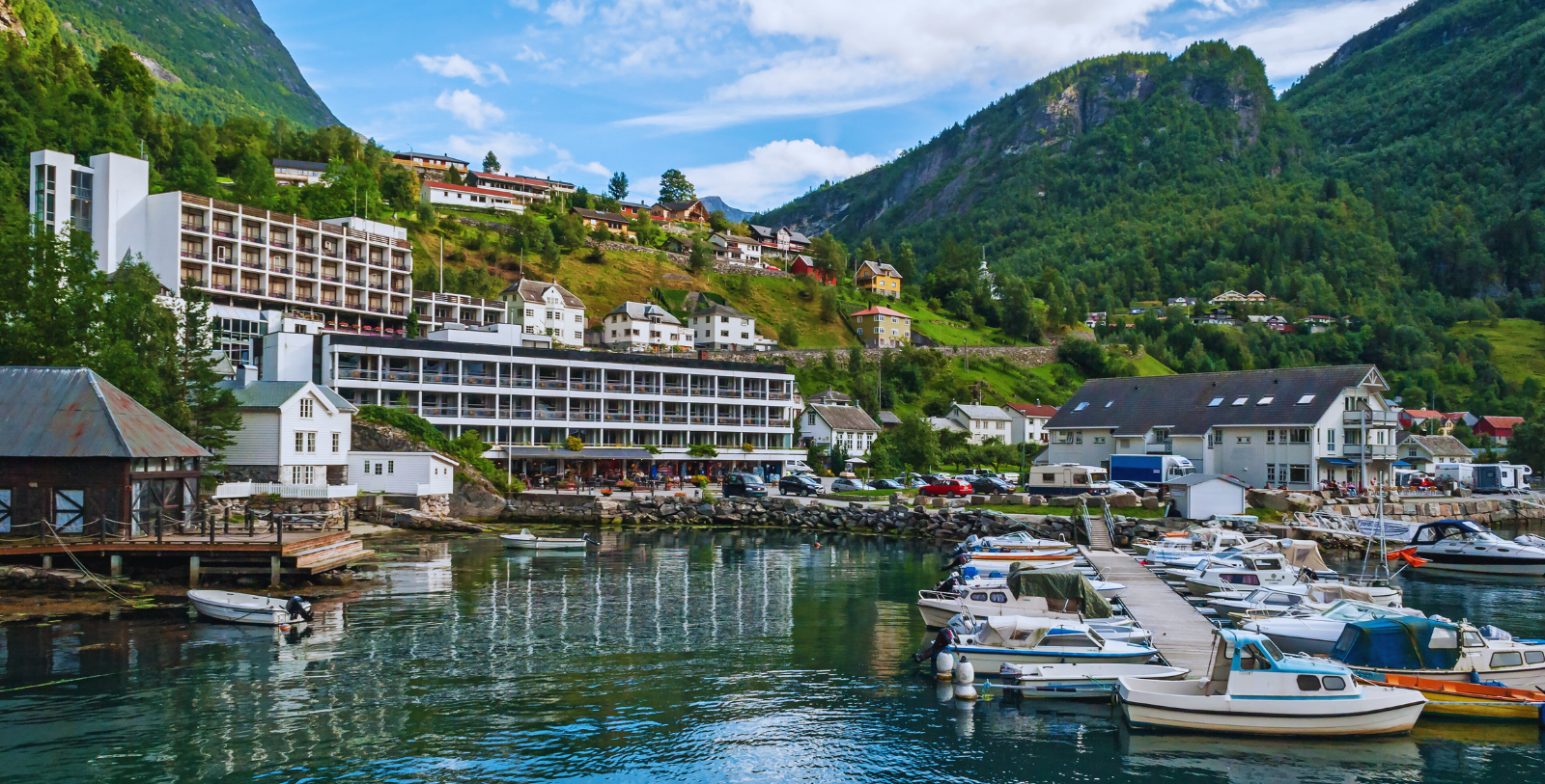 Explore the tiny community of Geiranger, a quaint hamlet at the head of the Geirangerfjord with a permanent population of only 250 villagers.