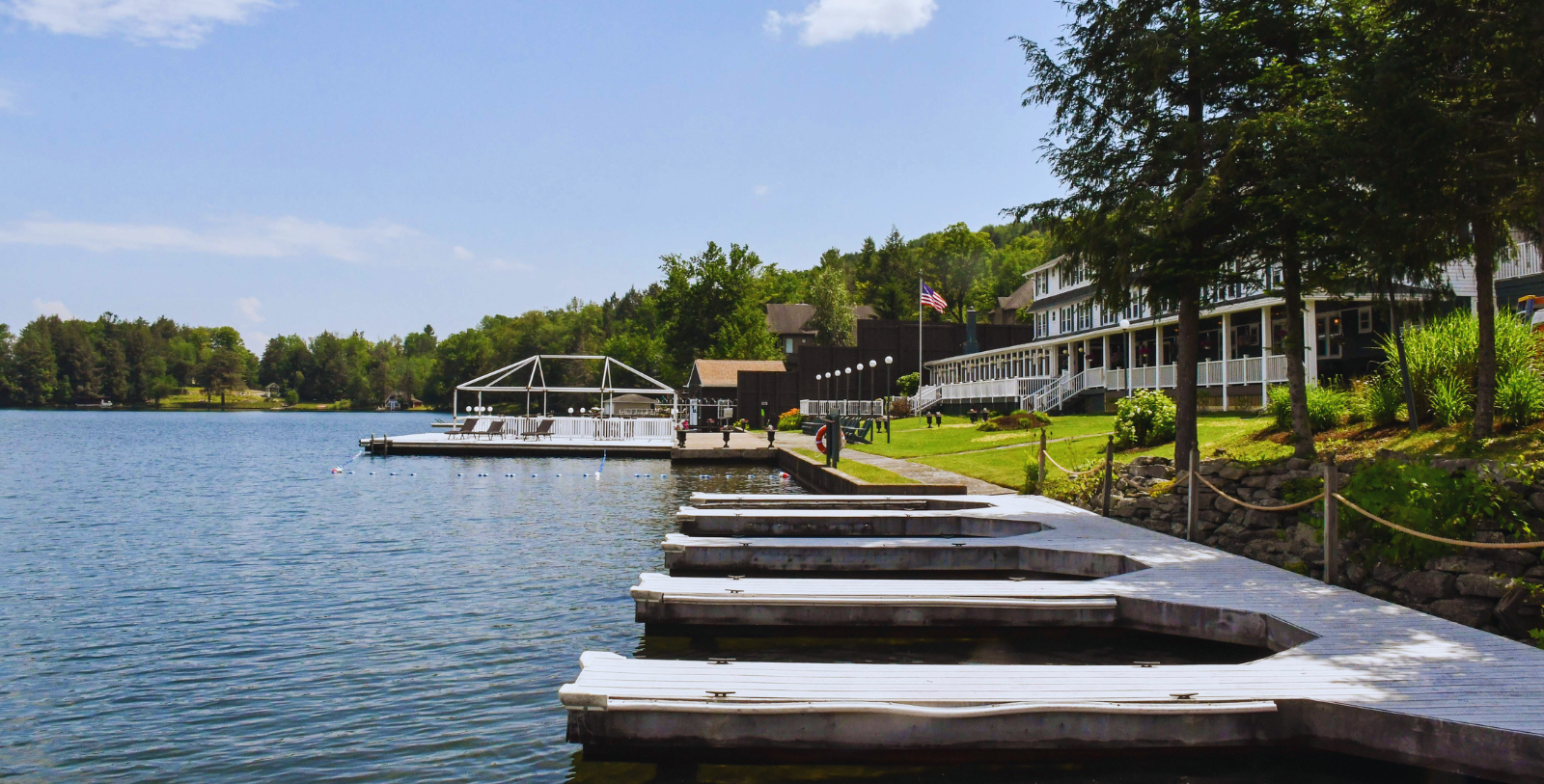 Image of Oquaga Lake and exterior of The Chestnut Inn, 1927, Member of Historic Hotels of America since 2023, in Deposit, New York