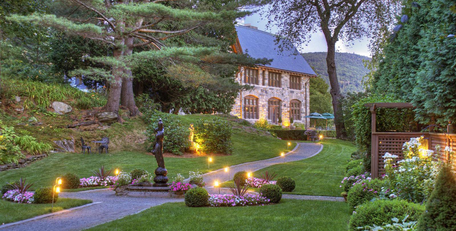 Image of hotel exterior at dusk at Castle Hill Resort and Spa, 1905, Member of Historic Hotels of America, in Cavendish, Vermont, Special Offers, Discounted Rates, Families, Romantic Escape, Honeymoons, Anniversaries, Reunions