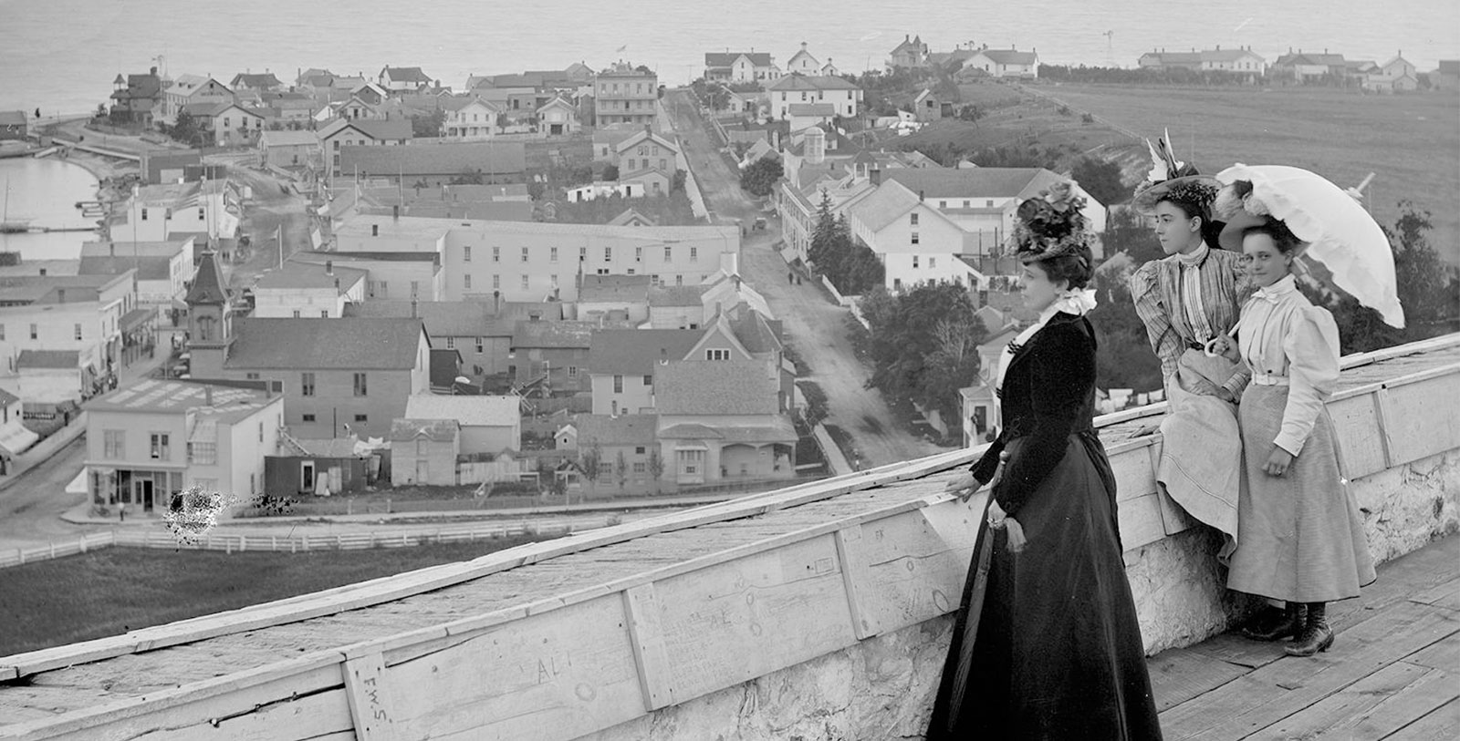 Discover the historic white façade of the Island House Hotel, Mackinac Island's Michigan Historic Landmark waterfront resort hotel, welcoming guests since 1852.