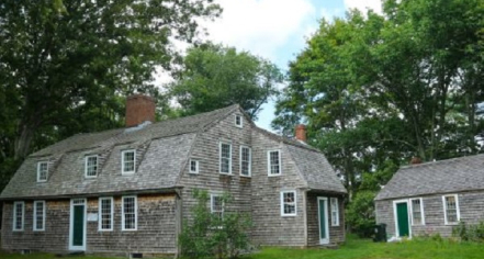 Image Of Two Buildings With Gray Wood Shingles And White Trimmed Windows.