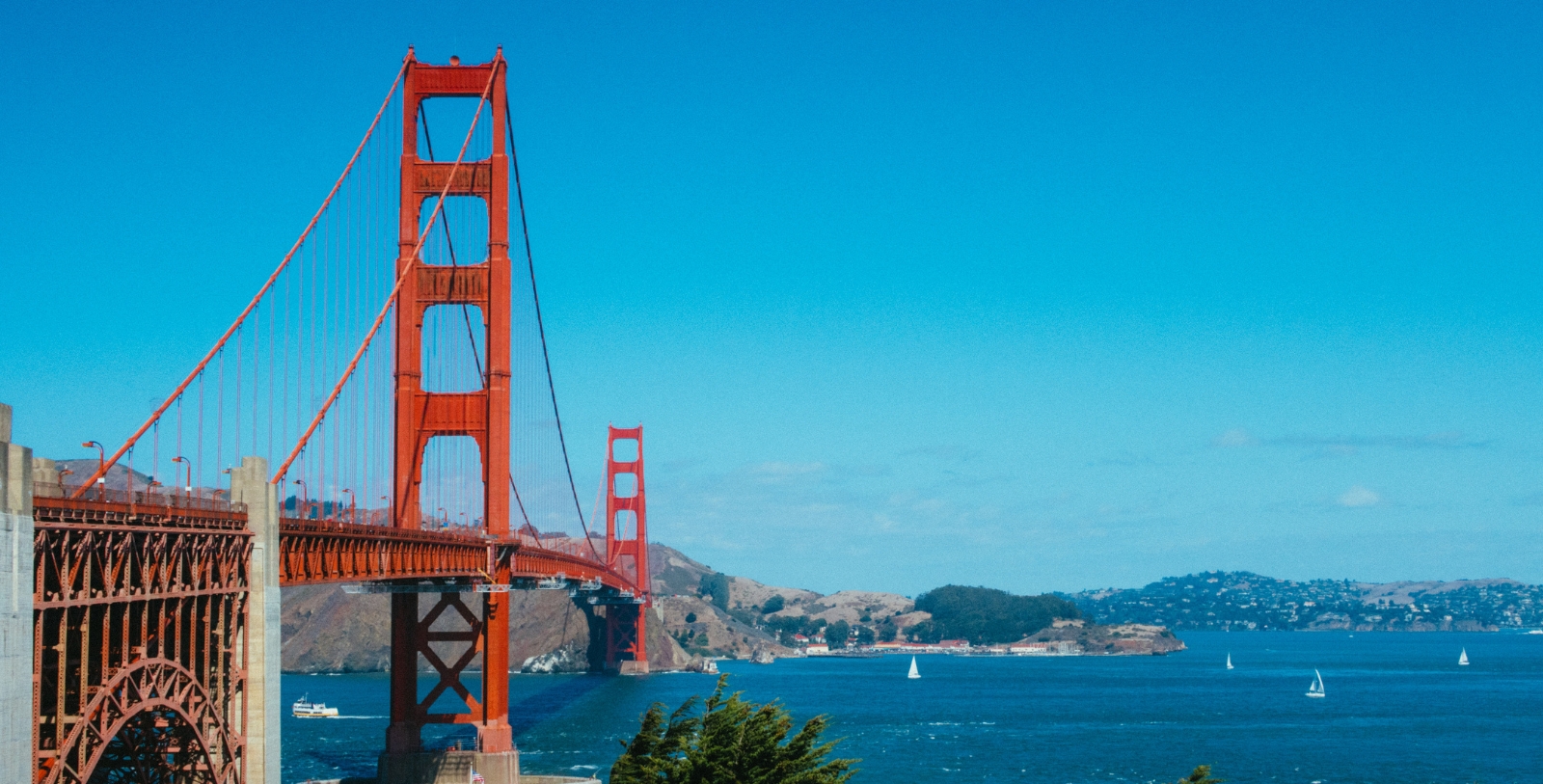 Explore the Bay Bridge and Golden Gate Bridge located on either side of San Francisco Bay.