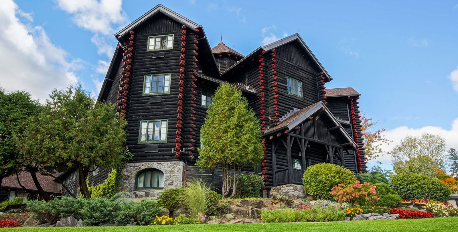 Image of Hotel Exterior with Guests Dogsledding Fairmont Le Château Montebello, 1930, Member of Historic Hotels Worldwide, in Montebello, Quebec, Overview