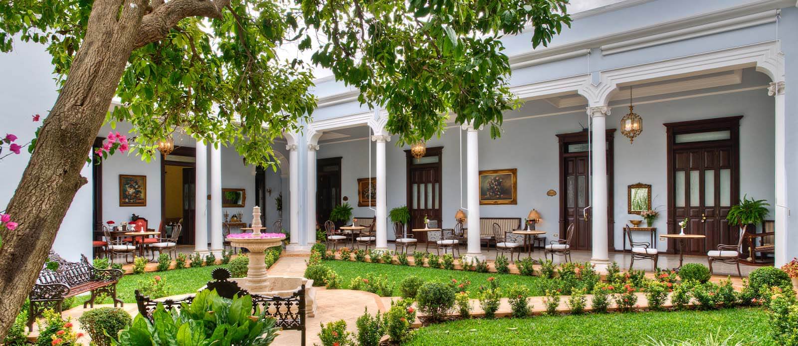 Daytime garden and courtyard of Casa Azul Hotel Monumento Historico in Merida, Mexico.